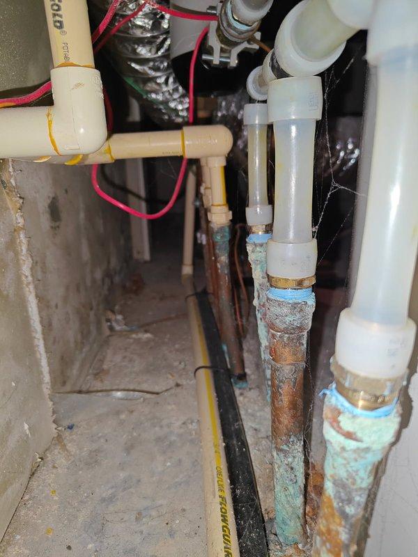 Inspected customer's water heater system and identified significant copper pipe corrosion at connection points, with visible verdigris formation indicating prolonged moisture exposure. Documented mold growth on mechanical room wall caused by inadequate ventilation in the small space. Recommended installation of a recirculating pump and implementation of improved ventilation solutions including a dehumidifier, fan, and proper pipe insulation to prevent further deterioration.