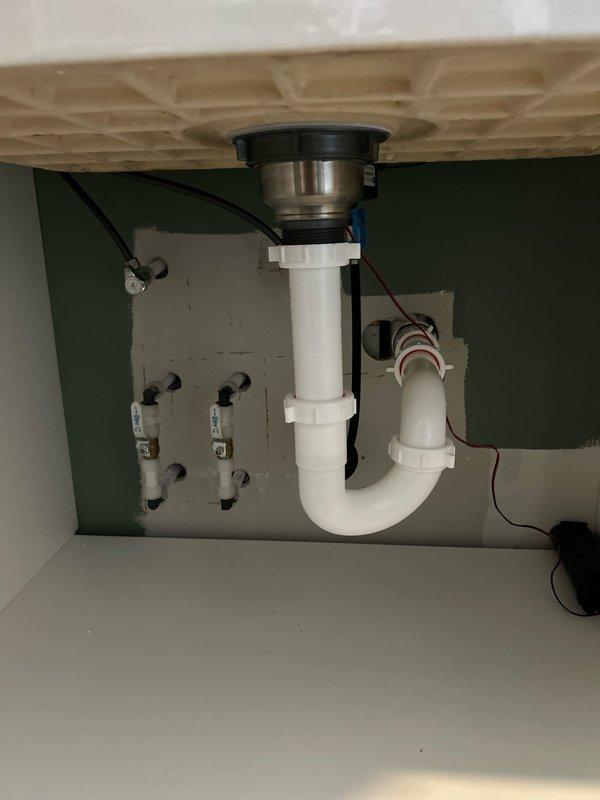 Completed installation of customer-supplied sink, faucet, basket strainer and P-trap assembly in laundry room. Properly connected new fixtures to existing plumbing lines and verified operation with no leaks.