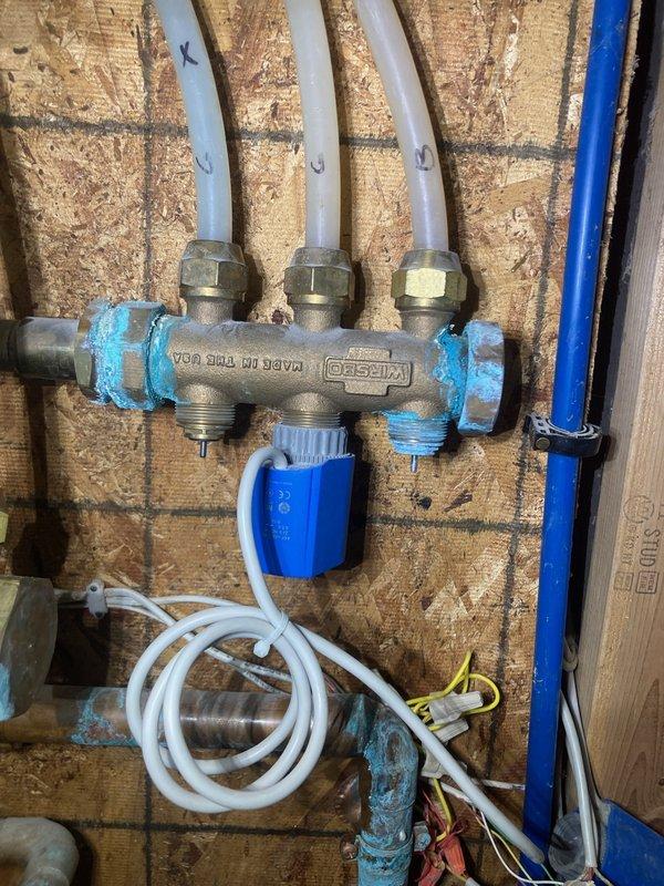 Inspected aging boiler system with leaking in-floor heating pump manifold at connection points. Identified blue sealant failure on KISSCO manifold with PEX distribution pipes. System is approximately 10+ years old with multiple obsolete components. After consultation with customer and colleague Dylan, recommended full boiler replacement and repiping due to system age and condition. Scheduled service advisor visit for replacement options and pricing.