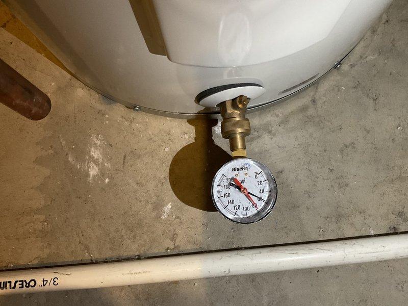 Responded to low water pressure complaint following recent water heater installation. Diagnostic testing revealed system pressure at approximately 30-40 PSI (below optimal range). Discovered significant mineral and sediment buildup in plumbing system, evidenced by substantial deposits in toilet tank components. Cleaned affected components and adjusted pressure regulator to restore proper water pressure throughout the residence.