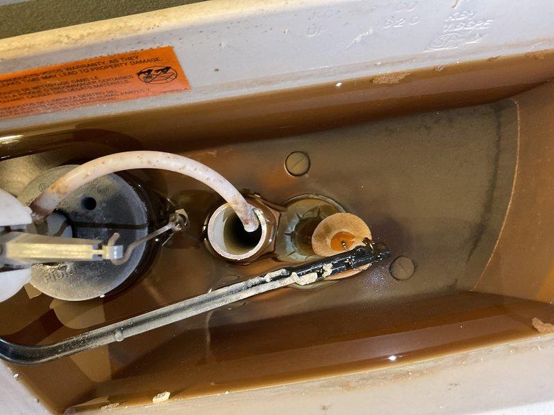 Responded to low water pressure complaint following recent water heater installation. Diagnostic testing revealed system pressure at approximately 30-40 PSI (below optimal range). Discovered significant mineral and sediment buildup in plumbing system, evidenced by substantial deposits in toilet tank components. Cleaned affected components and adjusted pressure regulator to restore proper water pressure throughout the residence.