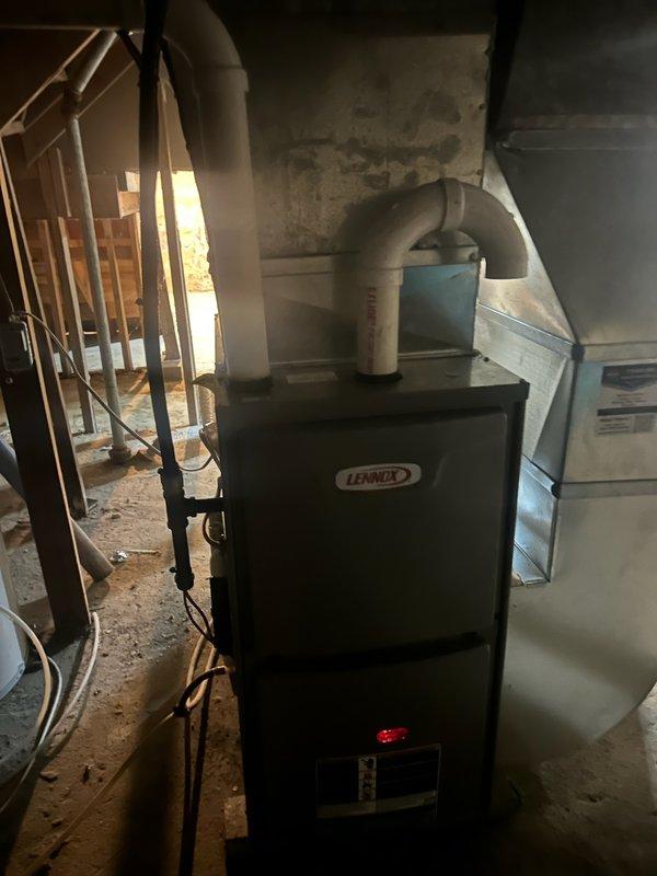 Performed comprehensive tune-ups on two furnaces in newly purchased property. First unit (older, smaller) was functioning properly with clean filter and blower, clear routine lines, and intact heat exchanger. Second unit (newer, larger) showed signs of secondary heat exchanger leakage; adjusted furnace pitch by an additional 1/8 inch to correct the issue. Both systems demonstrated proper operation during 15-minute test runs with appropriate temperature rises (70° and 60° respectively). Recommended AC inspection in spring.