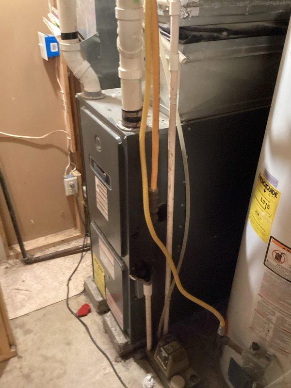 Responded to no heat call for aging furnace (10+ years old) that was cycling on but blowing cold air due to pilot light repeatedly extinguishing. Inspected heat exchanger and identified suspicious areas of potential deterioration. Cleaned flame sensor which temporarily resolved the immediate issue, allowing furnace to maintain operation. Noted that system never displayed error codes during flame sensor cycling, suggesting possible control board malfunction as secondary contributing factor.