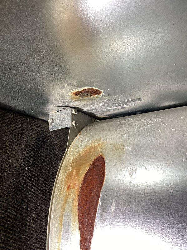 Inspected 10+ year old furnace after customer reported smoke and CO alarms activation. Found heat exchanger with concerning areas but no compromises, severely rotted inducer seal that leaked through the upper cabinet onto blower, blower wheel with 1/4" play, out-of-spec capacitor, and calcification buildup on secondary heat exchanger. System operated normally during 20-minute test run. Recommended customer obtain estimates for motor replacements, heat exchanger service, and possible unit replacement.