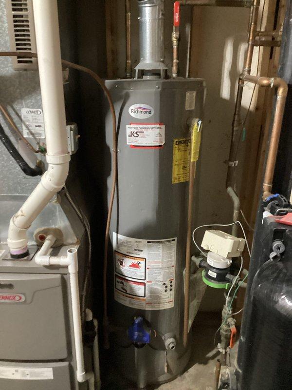 Responded to service call for non-functioning water heater. Upon inspection, determined existing Richmond tank-style water heater had failed due to age. Removed old unit and installed new replacement water heater, connecting all necessary copper and PVC piping. System now operating properly with hot water restored.