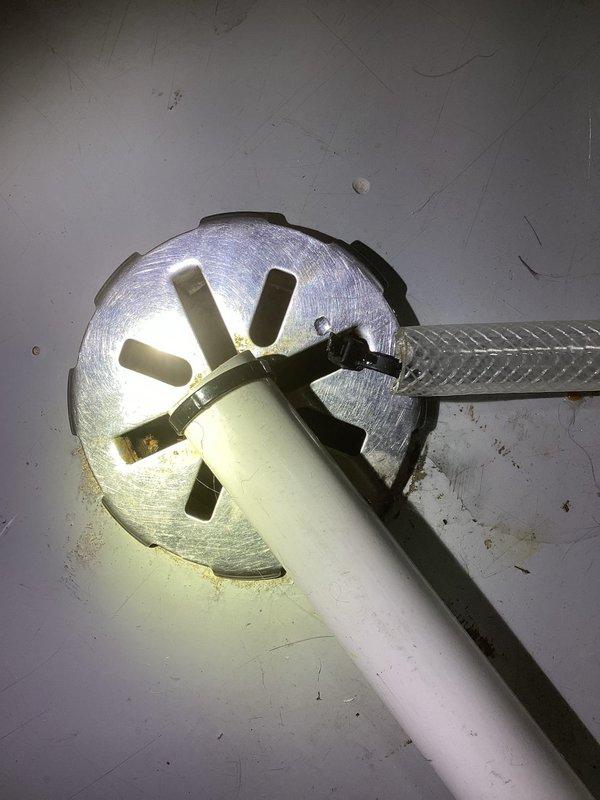 Diagnosed water leakage issue under furnace and hardwood floor. Investigation revealed improperly terminated water heater condensate drain was causing backflow. Resolved by correctly terminating the condensate drain at floor drain with an elbow, preventing further water damage.