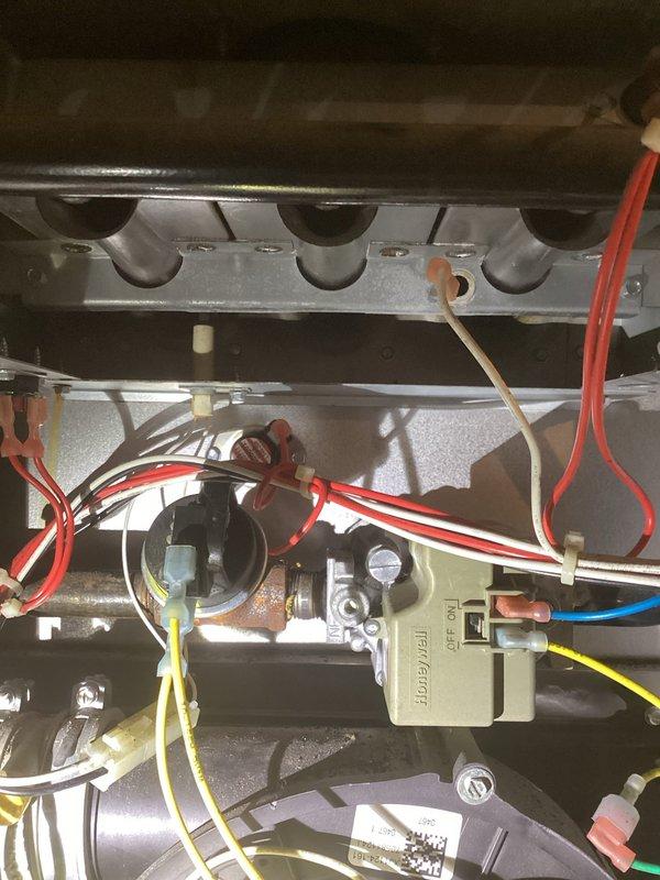 Responded to no heat complaint on 15-year-old LP furnace. Diagnosed plugged condensate trap which was cleaned to restore operation. Inspection revealed rusted burner assembly, deteriorating flame sensor, and noisy inducer motor. Heat exchanger inspection showed no cracks or holes. Recommended replacement of damaged components and scheduled follow-up service advisor consultation.