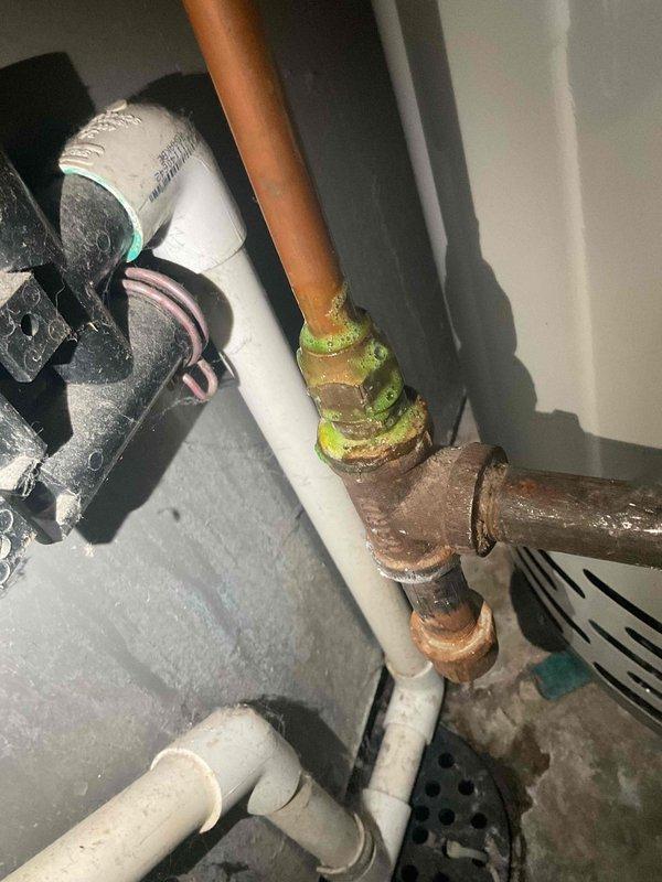 Responded to service call for gas leak detection at recently installed water heater. Upon inspection, identified loose gas fitting connection exhibiting significant corrosion at copper-to-brass joint. Resolved issue by tightening the connection and verified system integrity with no further gas odor detected.