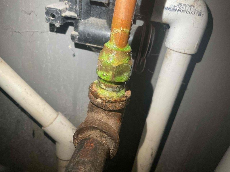 Responded to service call for gas leak detection at recently installed water heater. Upon inspection, identified loose gas fitting connection exhibiting significant corrosion at copper-to-brass joint. Resolved issue by tightening the connection and verified system integrity with no further gas odor detected.