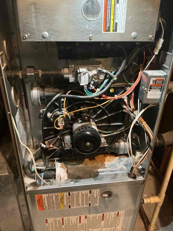 Diagnosed intermittent heating failure in 17-year-old furnace caused by pressure switch opening issues. Visual inspection revealed multiple critical problems: likely plugged secondary heat exchanger, oil leakage from blower motor, and leaking condensate collector box. Scheduled replacement estimate due to age and multiple component failures.