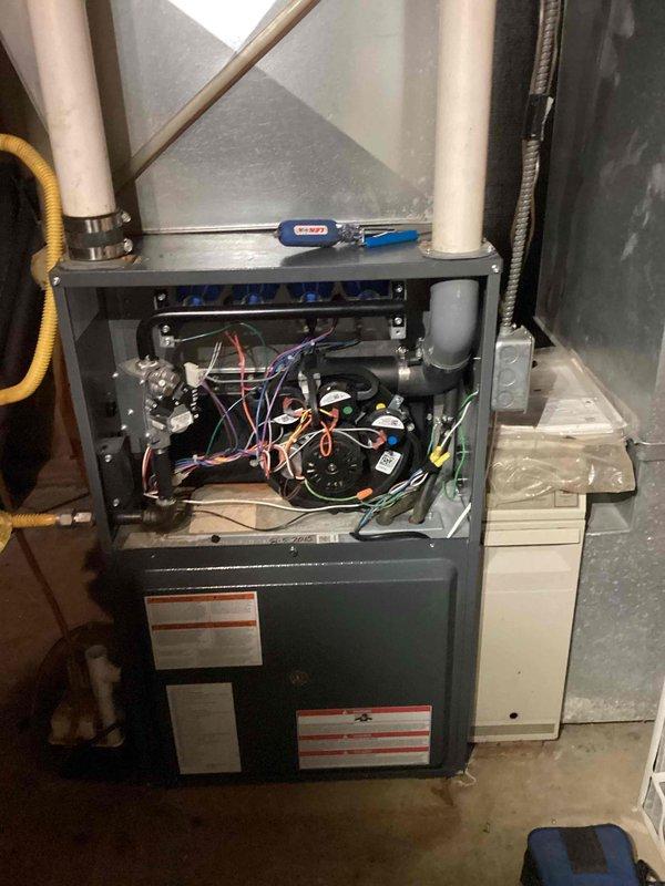 Responded to no heat call for Goodman GMVC960804CNAA furnace (manufactured 2015). Diagnosed locked combustion blower as the source of failure. Removed front panel, accessed internal components, and replaced combustion blower to restore proper operation. Enrolled customer in rewards membership program. Unit now functioning correctly with heat restored.
