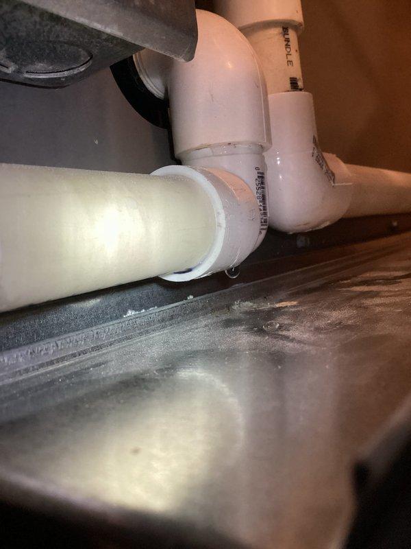 Responded to service call for 4-year-old furnace with water leakage causing minor rust on panel. Diagnostic inspection revealed faulty condensate drain fittings. Performed necessary repairs by cutting out compromised fittings and installing new properly secured PVC connections. Verified system operation post-repair with no further leakage observed.