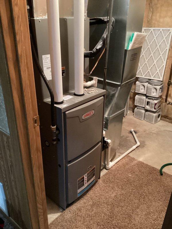 Responded to service call for 4-year-old furnace with water leakage causing minor rust on panel. Diagnostic inspection revealed faulty condensate drain fittings. Performed necessary repairs by cutting out compromised fittings and installing new properly secured PVC connections. Verified system operation post-repair with no further leakage observed.