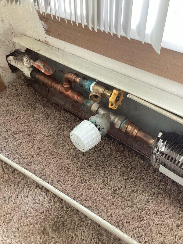 Responded to no-heat complaint in Unit 108 located at end of boiler distribution system. Diagnosed restricted flow issue in radiator piping. Drained approximately two gallons of contaminated water from system via existing drain valve, which restored proper circulation. Replenished system water level after draining. Verified heating function restored to apartment. Maintenance staff confirmed this is a recurring issue requiring periodic flushing of this terminal section of the distribution system.