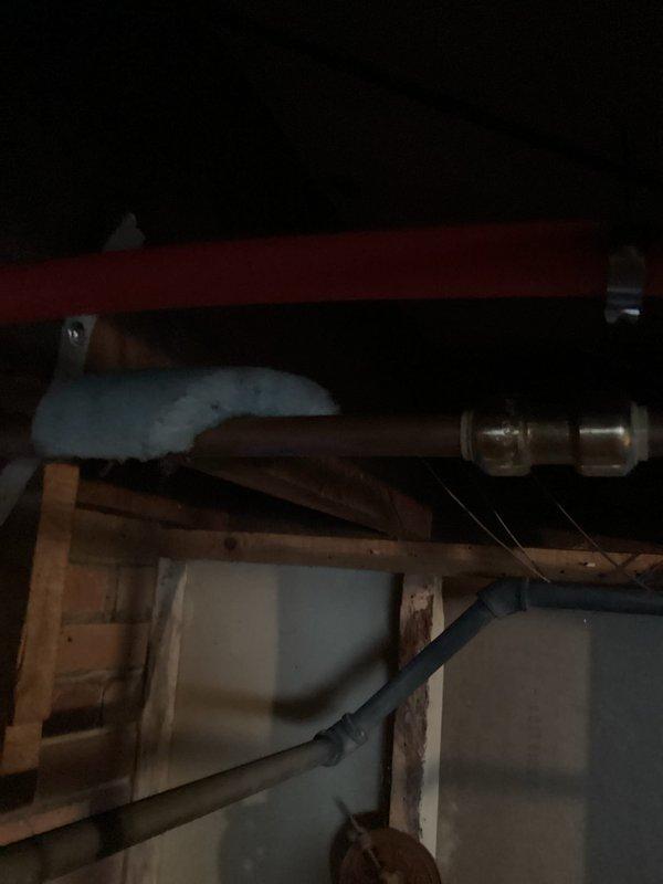 Responded to emergency service call for leaking pipe at top of water heater system with integrated boiler. Located pinhole leak in copper pipe running to dishwasher. Cut out damaged section of pipe and replaced it to resolve the leak, restoring proper function to both water heater and connected boiler system.