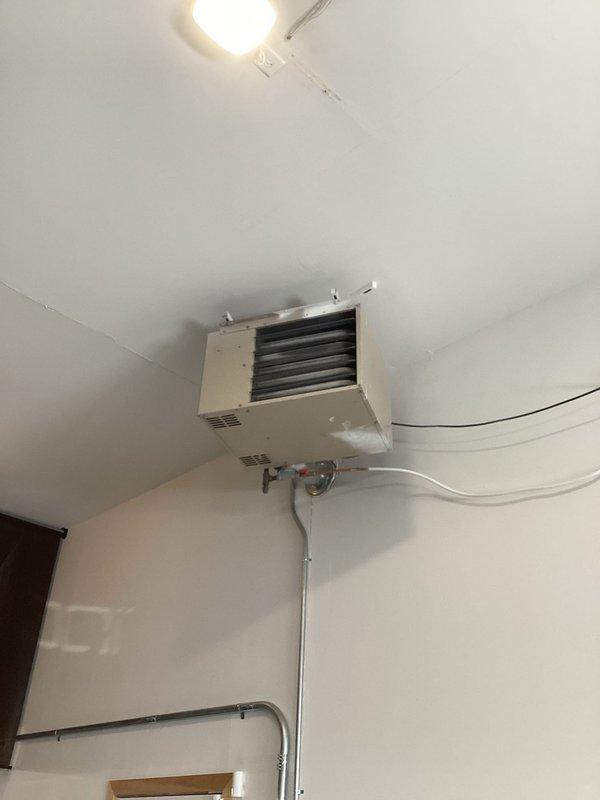 Responded to no-heat call for wall-mounted garage heater that was previously serviced. Diagnosed system, which fired up and operated normally during 20-minute test run. Performed preventative maintenance including cleaning flame sensor and igniter. Verified proper gas pressure and confirmed all electrical components and settings were functioning correctly. Unit now operating as designed with customer instructed to monitor and report if issue recurs.