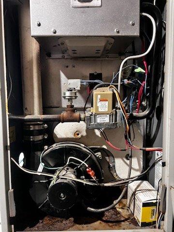 Responded to no heat complaint for a 1999 Heil furnace. Diagnostic inspection revealed multiple critical failures including a burned out igniter, cracked heat exchanger, and severely rusted exhaust pipe. Due to safety concerns and extensive deterioration, recommended immediate system replacement and provided temporary space heaters until replacement could be installed.