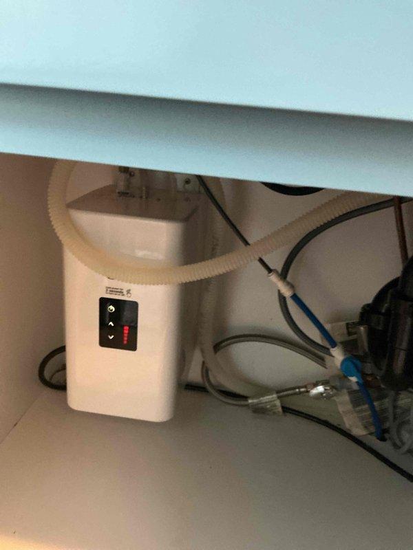 Repaired water leak under kitchen sink by reconnecting loose tube to hot water tank. Identified and resolved secondary issue by turning on previously shut-off refrigerator water valve downstairs, restoring water supply to both sink and refrigerator.