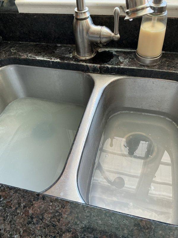Responded to service call for kitchen sink drainage issue. Upon arrival, found sink with standing water and previously applied Drano. Successfully cleared blockage using drain cleaning machine, restoring proper drainage function to kitchen sink.