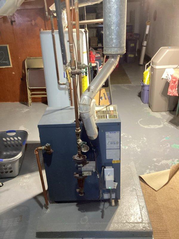 Diagnosed 1991 boiler unable to maintain desired temperature (67°F actual vs 70°F setpoint) during extreme cold weather. Increased water temperature settings to extend run time and improve heating capacity. Scheduled follow-up estimate for replacement with a more efficient system better suited to handle current heating demands.