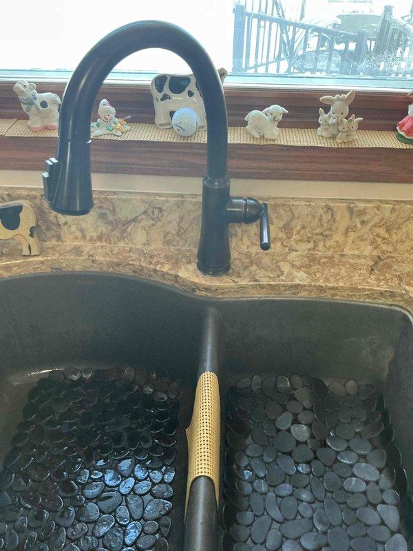 Responded to service call for kitchen sink drainage issue that was backing up during dishwasher operation. Diagnostic inspection revealed clogged kitchen sink drain causing water to back up when dishwasher discharged. Successfully cleared the obstruction using drain auger, restoring proper drainage function to both sink and dishwasher discharge line.