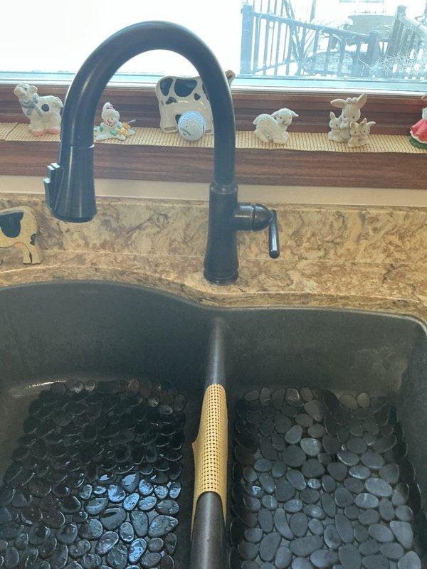Responded to service call for kitchen sink drainage issue that was backing up during dishwasher operation. Diagnostic inspection revealed clogged kitchen sink drain causing water to back up when dishwasher discharged. Successfully cleared the obstruction using drain auger, restoring proper drainage function to both sink and dishwasher discharge line.
