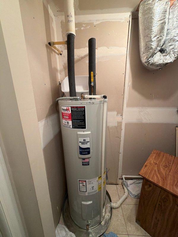 Responded to emergency water leak caused by a broken 3" water heater vent cap that allowed rainwater to infiltrate and flood the residence. Upon arrival, located the source of flooding and verified the main water supply had been shut off. Installed a new 3" Fernco cap on the water heater vent pipe (labeled "W/H VENT") to prevent further water intrusion. Explained to homeowner the service response protocols for after-hours emergency calls.