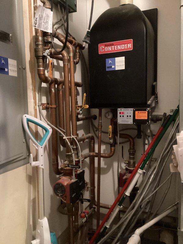 Performed comprehensive tune-up on two 18-year-old furnaces prior to home sale. First unit inspection included component cleaning, condensate drainage verification, and heat exchanger examination which revealed concerning spots (non-compromised); system demonstrated proper operation with 55° temperature rise. Second furnace required thorough condensate line cleaning due to significant blockage; heat exchanger inspection also revealed concerning areas. Homeowner was informed about age-related wear on both units and plans to explore replacement options through home warranty program.