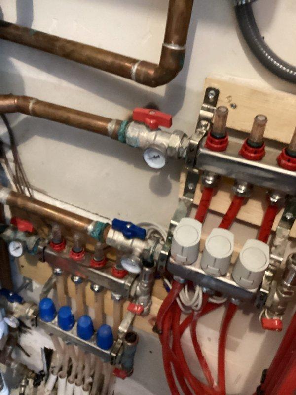 Responded to no-heat call for aging boiler system showing Low Water Pressure error. Utilized transfer pump to replenish water in the closed hydronic heating system, which services in-floor heating on lower level and portions of upper floor. During diagnostics, identified water leakage from manifold zone actuator requiring replacement, along with evidence of water damage to additional components. Recommended replacement of upstairs manifold pump flange and faulty pressure gauge. Restored system pressure to operational levels and provided repair estimates.