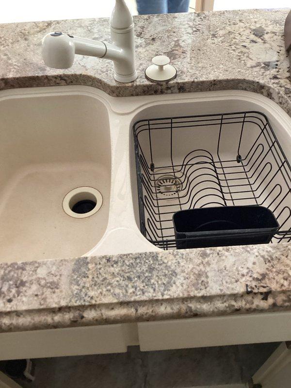 Conducted estimate for replacement of existing undermount kitchen sink in granite/marble countertop with double basin configuration. Inspected current installation, including pull-down faucet and soap dispenser. Evaluated under-sink water filtration system with multiple filter cartridges and associated plumbing connections for compatibility with new sink installation.