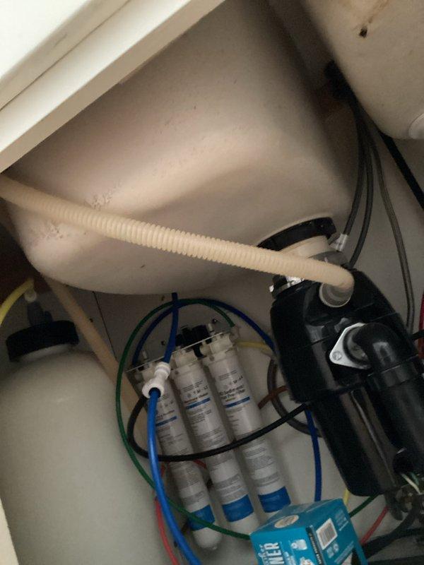 Conducted estimate for replacement of existing undermount kitchen sink in granite/marble countertop with double basin configuration. Inspected current installation, including pull-down faucet and soap dispenser. Evaluated under-sink water filtration system with multiple filter cartridges and associated plumbing connections for compatibility with new sink installation.