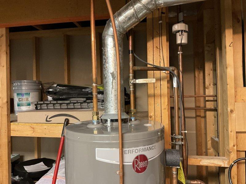 Responded to service call for leaking 40-gallon water heater producing no hot water. Determined existing unit was not repairable and replaced with new 50-gallon natural gas standard vent water heater. Installation included proper drain pan connected to floor drain to prevent future water damage.