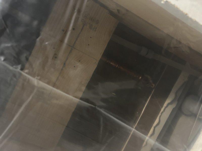 Completed installation of customer-supplied shower valve as previously assessed by Charlie. Removed existing valve and installed new replacement unit in tiled bathroom area. Work involved accessing plumbing behind framed wall structure.