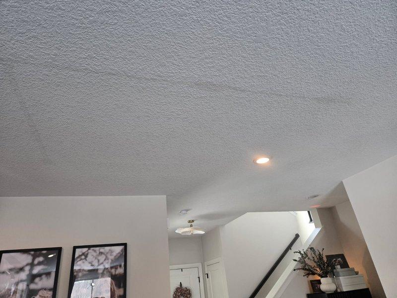 Investigated reported ceiling water stains in living room. Performed thorough inspection of upstairs bathroom plumbing and ceiling cavity but found no active leaks. Determined stains likely resulted from one of three causes: HVAC condensation, inadequate bathroom ventilation causing humidity buildup, or water spillage from children's baths. Advised client that sheetrock repair will be required by a specialist.