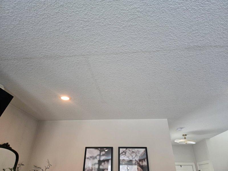 Investigated reported ceiling water stains in living room. Performed thorough inspection of upstairs bathroom plumbing and ceiling cavity but found no active leaks. Determined stains likely resulted from one of three causes: HVAC condensation, inadequate bathroom ventilation causing humidity buildup, or water spillage from children's baths. Advised client that sheetrock repair will be required by a specialist.