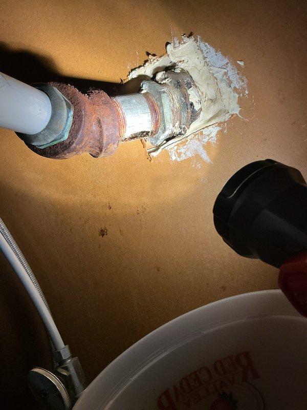 Responded to kitchen sink leak caused by a hole in galvanized nipple. Replaced deteriorated galvanized pipe fitting with new PVC components and installed proper P-trap assembly to ensure proper drainage and eliminate leak.