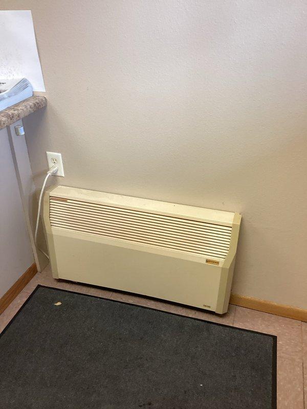 Inspected Myson wall heater that was reported as underperforming. Noted unit has been operating without a filter, likely causing dust accumulation and reduced efficiency. Observed significant gap under nearby door contributing to heat loss. Recommended thorough cleaning of unit in spring to avoid potential complications during cold weather operation.