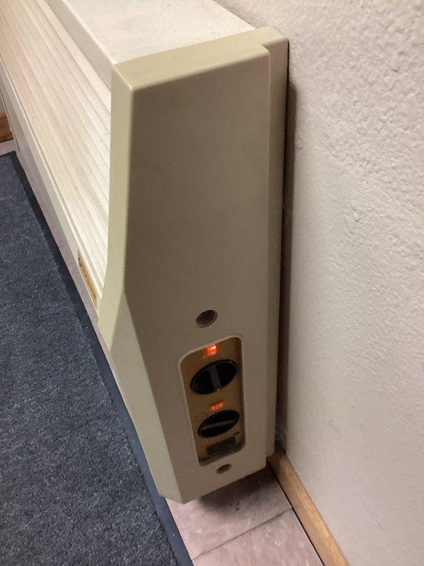 Inspected Myson wall heater that was reported as underperforming. Noted unit has been operating without a filter, likely causing dust accumulation and reduced efficiency. Observed significant gap under nearby door contributing to heat loss. Recommended thorough cleaning of unit in spring to avoid potential complications during cold weather operation.