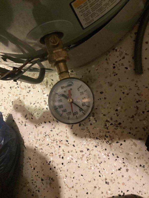 Installed a new adjustable water pressure regulator (up to 1") to replace failing unit. Initial testing showed pressure readings of approximately 50-60 PSI on the Bluefin gauge. The regulator was properly mounted to the concrete block wall with copper and PVC connections, ensuring optimal water pressure throughout the property and protecting pipes and fixtures from excessive pressure damage.