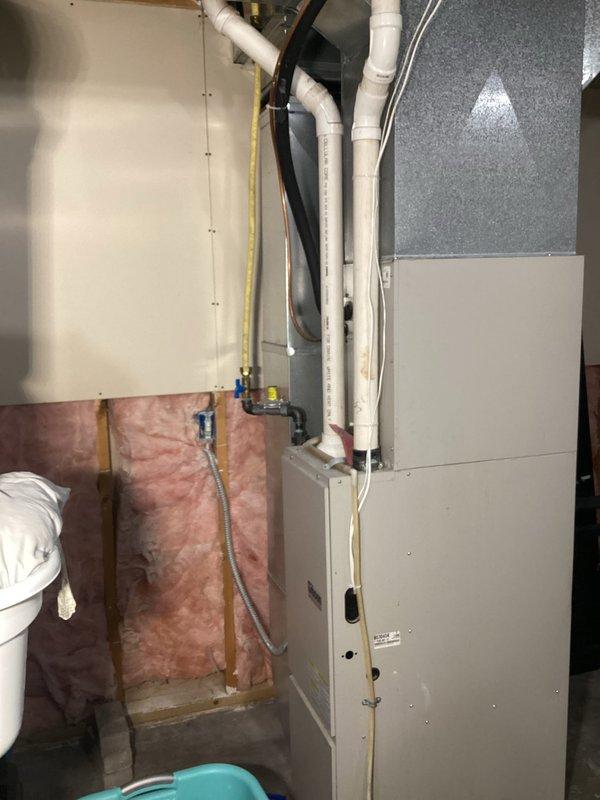 Responded to service call for 80-gallon AO Smith electric water heater installed in 2022 that was leaking from the bottom. Diagnosed tank failure with no water at connection points. Replaced water heater under manufacturer warranty.