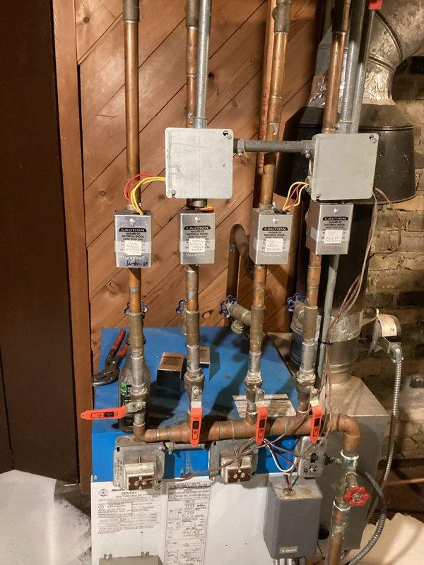 Inspected 20-year-old 4-zone boiler system after customer complaint of one zone not heating. Determined that the laundry/dining room zone has a frozen section of baseboard fin tube extending from the laundry room into the crawl space. Customer's actuator replacement did not resolve the issue. Prepared estimate for cutting out and repairing the frozen section.