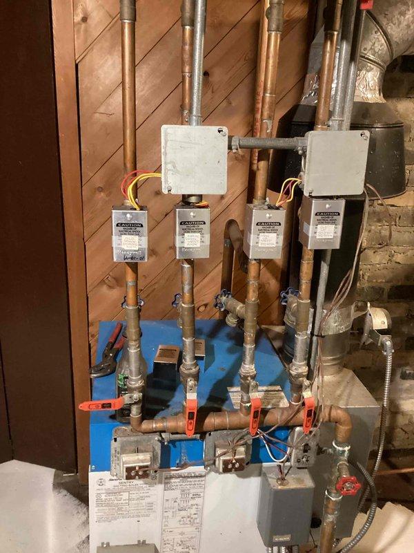 Inspected 20-year-old 4-zone boiler system after customer complaint of one zone not heating. Determined that the laundry/dining room zone has a frozen section of baseboard fin tube extending from the laundry room into the crawl space. Customer's actuator replacement did not resolve the issue. Prepared estimate for cutting out and repairing the frozen section.