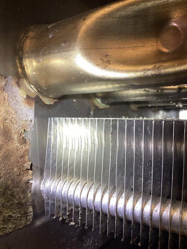 Performed comprehensive furnace tune-up including inspection of heat exchanger, cleaning of flame sensor, verification of proper condensate drainage, and testing of electrical components. All systems functioning normally with appropriate 60° temperature rise. Identified slightly dirty air filter requiring replacement and adjusted heating elements on customer's electric water heater to address reported hot water supply issues.