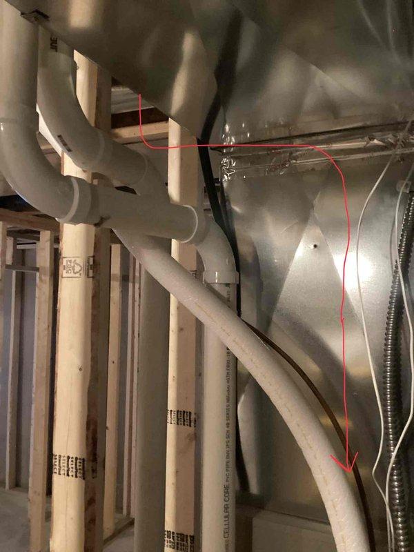 Assessed basement construction project where lineset from furnace to exterior conflicts with planned bathroom framing. Documented current installation with exposed PVC plumbing, metal ductwork, and copper lineset routing issues. Relocation of copper line required; recommended scheduling installation team to determine appropriate rerouting solution for HVAC components.