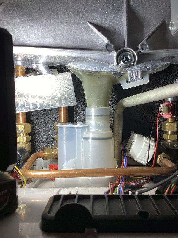 Responded to service call for boiler leaking water with active low pressure light. Upon inspection, identified loose condensate trap that had been previously replaced. Tightened the screw-on trap securely, resolving the leak issue. System returned to normal operation with no further adjustments needed.