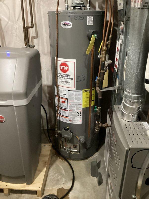 Responded to service call for Richmond water heater leaking. Upon inspection, identified an inner tank leak in the approximately 40-gallon gas water heater with standard venting. Diagnosed as non-repairable tank failure and presented replacement options to customer.