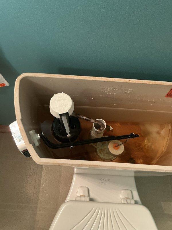 Inspected four toilets reported as leaking. Diagnosed one toilet with a faulty fill valve causing continuous running. Removed corroded original fill valve showing significant mineral deposits and rust. Installed new fill valve assembly to restore proper tank filling operation and eliminate water waste.