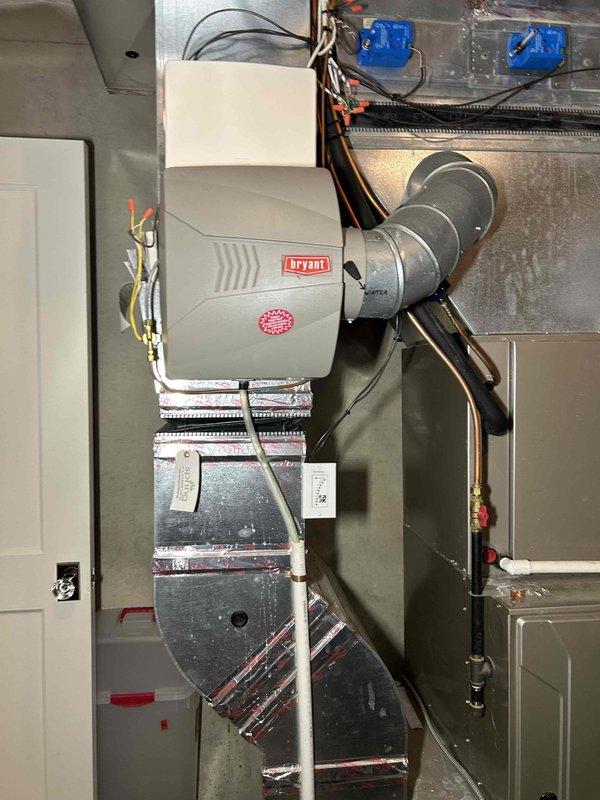 Performed routine furnace tune-up on Bryant system. Conducted comprehensive inspection including heat exchanger evaluation, combustion analysis, gas pressure verification (HI/LO stage), flame sensor and burner examination, and blower motor assessment. System operating normally with no immediate concerns identified. Cleaned pressure switch and confirmed proper thermostat operation. Air filter in moderate condition. Documented system components with photos of main humidifier unit, ductwork, and associated electrical connections.