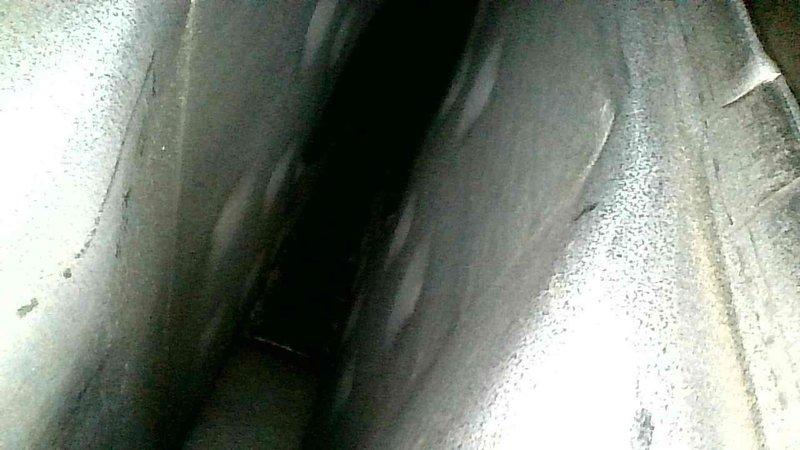 Responded to no heat complaint at rental property. Inspection of aging furnace revealed significant issues with the collector box seal at the inducer motor connection, allowing leakage. Performed comprehensive heat exchanger inspection including scope examination and diagnostic drilling, with no visible cracks or pitting observed. Discussed findings with property manager regarding limited repair options due to internal collector box location being attached directly to heat exchanger.