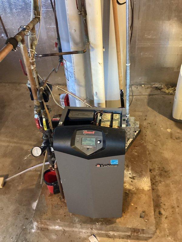 Diagnosed boiler system operating at 30% capacity with outlet temperature of 170°. System functioning as designed but requires cleaning when weather permits; current exterior temperature (-20°F) made immediate cleaning inadvisable. Identified significant heat loss due to structural wall damage allowing cold air infiltration around rim joist; recommended structural repairs to improve heating efficiency. Customer will schedule future cleaning service.